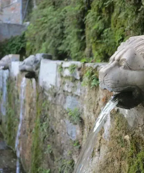 Lion-head fountain spouts carved in stone at Ménites - Euboea, Greece
