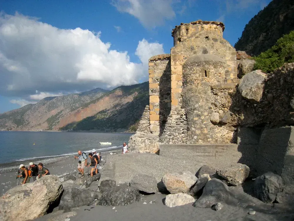 Hikers at Agios Pavlos chapel on the beach - Crete - Greece